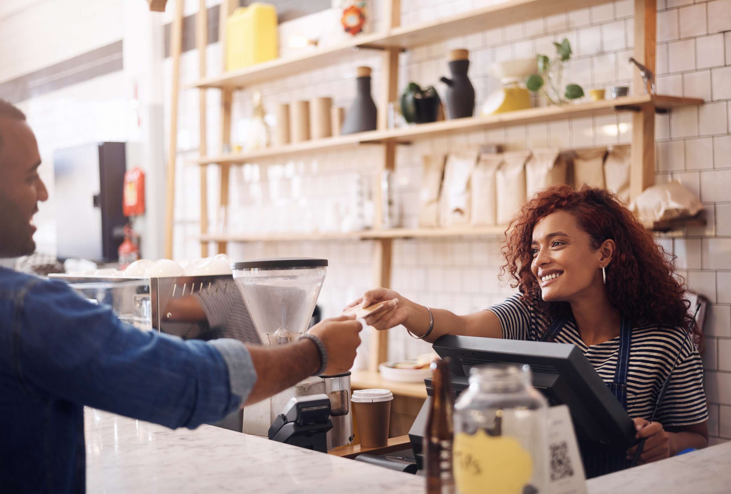 Girl in a cafe taking payment from a customer