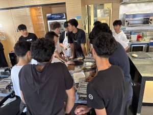 High School Students in kitchen learning to make pasta
