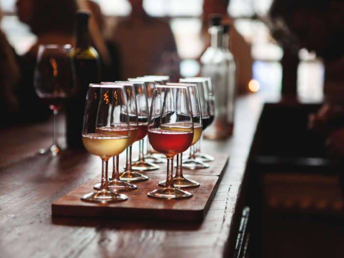 Sampler tray of red and white wines in glasses at winery