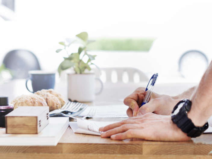 Man Writing Document Dinning Table Concept
